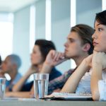 Creative business team listening at meeting in conference room in office